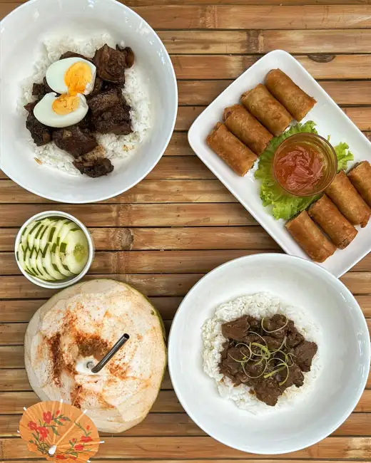 Adobo, bistek tagalog, and lumpia dishes at La Tortue dining